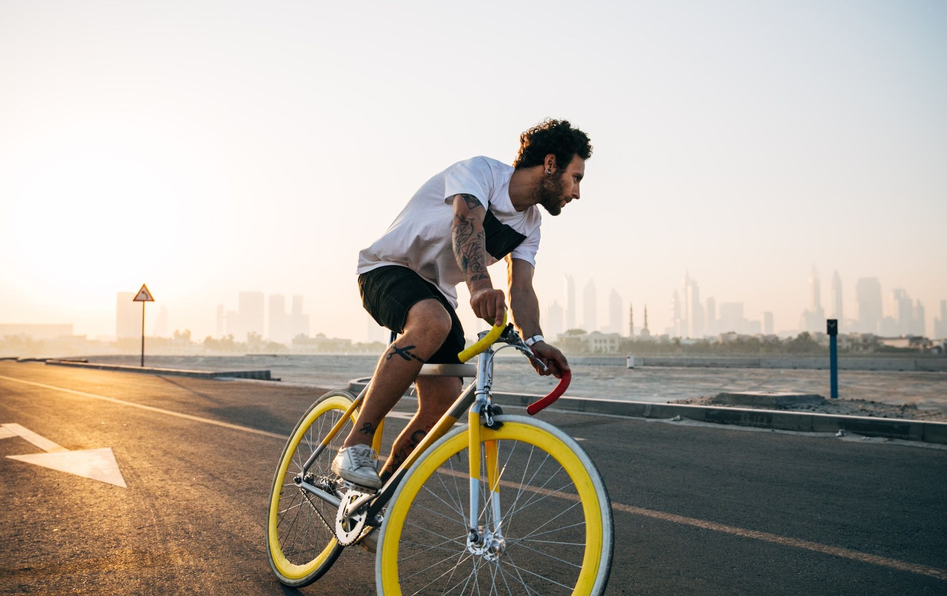 man on bicycle with yellow wheels